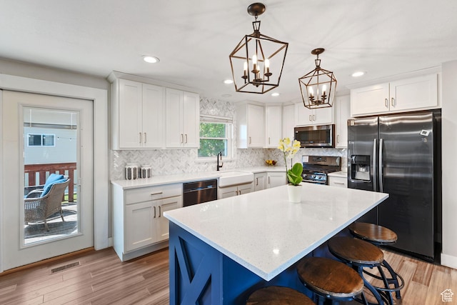 1265 W 1625 S, Syracuse, UT 84075 - kitchen with appliances with stainless steel finishes, a sink, white cabinetry, decorative backsplash, and recessed lighting