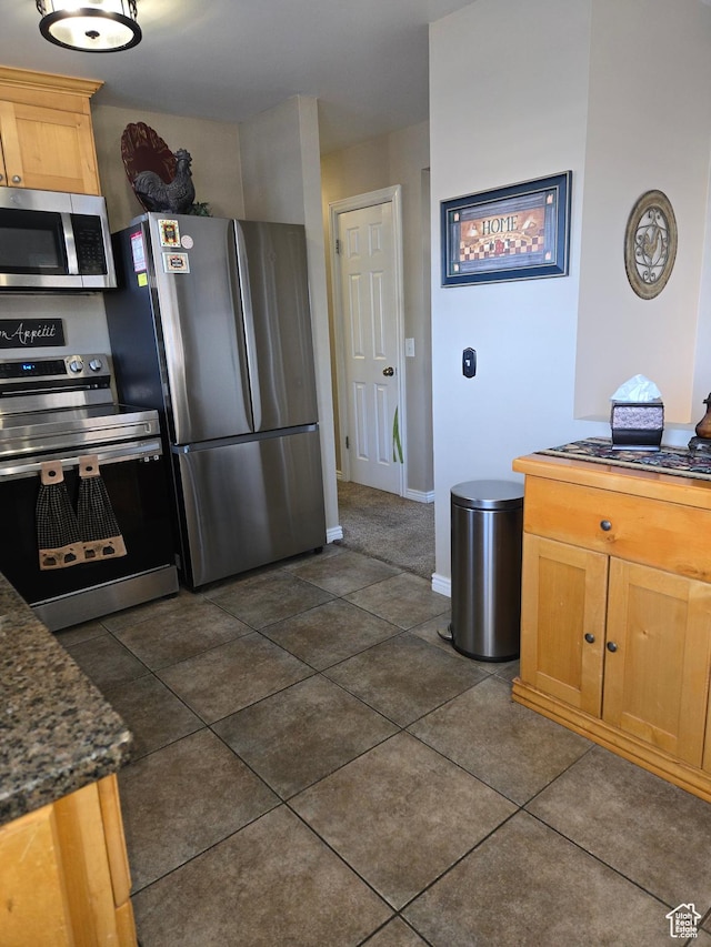 1549 W Marty Cir W, West Jordan, UT 84084 - kitchen featuring appliances with stainless steel finishes, dark countertops, baseboards, and dark tile patterned flooring