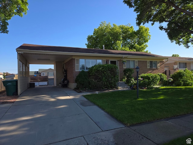 1549 W Marty Cir W, West Jordan, UT 84084 - view of front of property featuring a carport, brick siding, and driveway