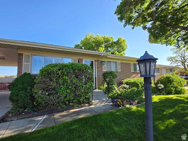 1549 W Marty Cir W, West Jordan, UT 84084 - ranch-style house featuring brick siding and a front yard
