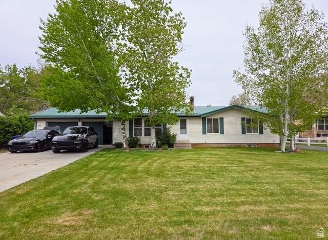 125 S 100 W, Morgan, UT 84050 - ranch-style house with driveway, a garage, and a chimney