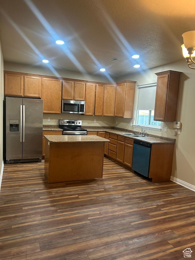 4673 W Greensand Dr, West Jordan, UT 84084 - kitchen featuring stainless steel appliances, dark wood-type flooring, recessed lighting, a center island, and a sink
