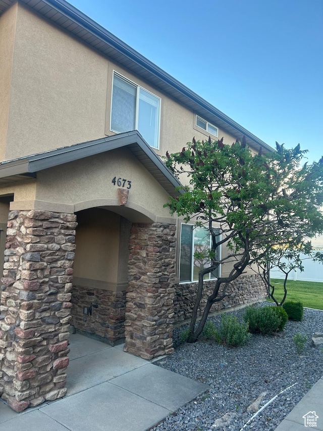 4673 W Greensand Dr, West Jordan, UT 84084 - doorway to property with stucco siding and stone siding
