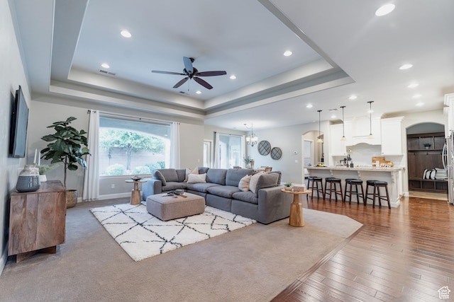 3288 W 2570 S, Hurricane, UT 84737 - living area with a tray ceiling, ceiling fan, arched walkways, recessed lighting, and wood finished floors