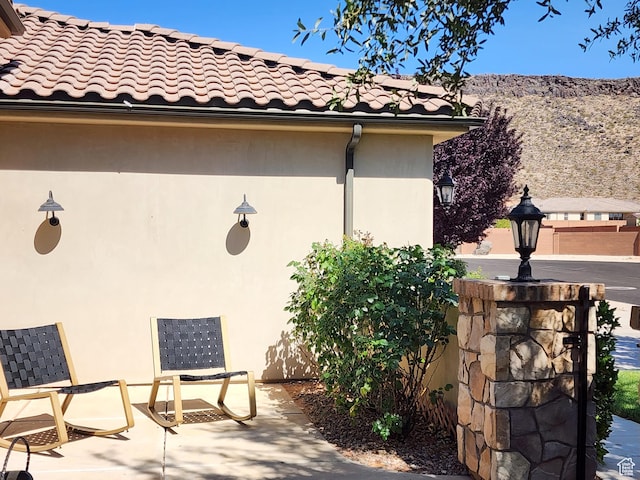 3288 W 2570 S, Hurricane, UT 84737 - view of side of home with stucco siding, a tiled roof, and a mountain view