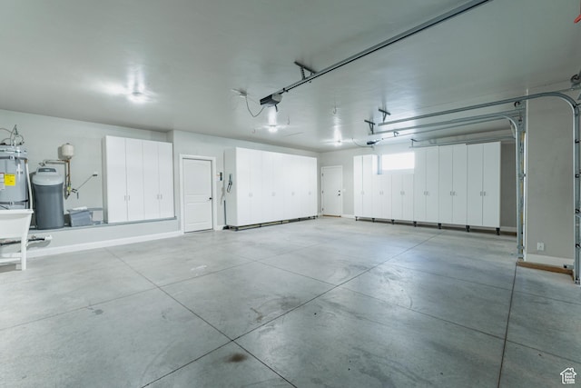 3288 W 2570 S, Hurricane, UT 84737 - garage featuring a garage door opener, baseboards, and water heater