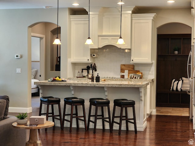 3288 W 2570 S, Hurricane, UT 84737 - kitchen featuring arched walkways, backsplash, white cabinets, and recessed lighting