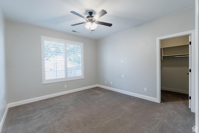 3288 W 2570 S, Hurricane, UT 84737 - unfurnished bedroom featuring dark colored carpet, a walk in closet, baseboards, and ceiling fan