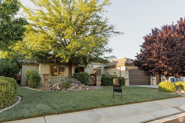 3288 W 2570 S, Hurricane, UT 84737 - view of front of home with stone siding, stucco siding, a front yard, and an attached garage