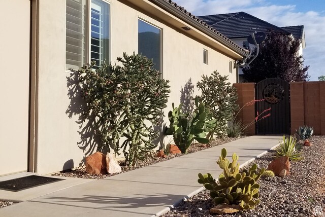 3288 W 2570 S, Hurricane, UT 84737 - view of home's exterior with a gate and stucco siding