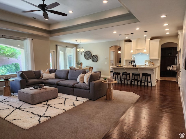 3288 W 2570 S, Hurricane, UT 84737 - living room featuring arched walkways, ceiling fan, recessed lighting, dark wood-style floors, and a chandelier