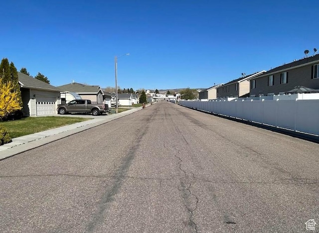 448 Alamo St, Chubbuck, ID 83202 - view of asphalt road with a residential view and street lighting