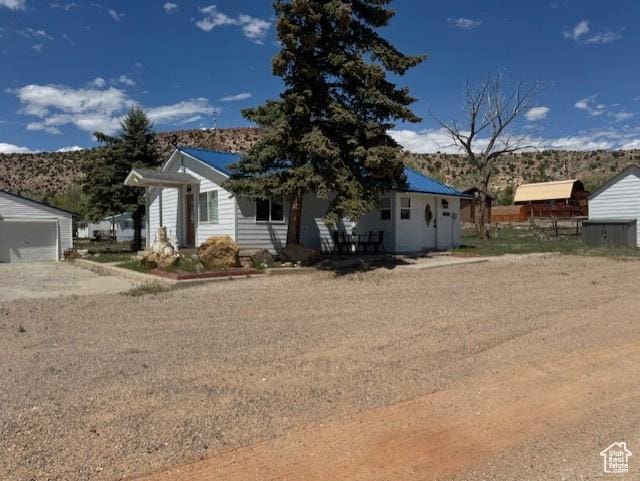 345 N 1st E, Manila, UT 84046 - view of front of home featuring an outdoor structure and a mountain view