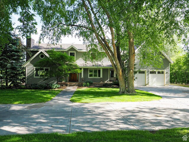 919 E 13800 S, Draper, UT 84020 - view of front of home with driveway, a chimney, a garage, and a front lawn