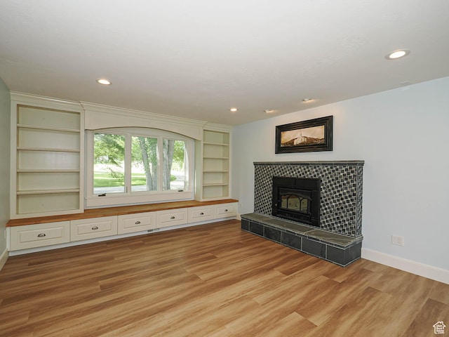 919 E 13800 S, Draper, UT 84020 - unfurnished living room with light wood-style floors, baseboards, a fireplace, recessed lighting, and built in features