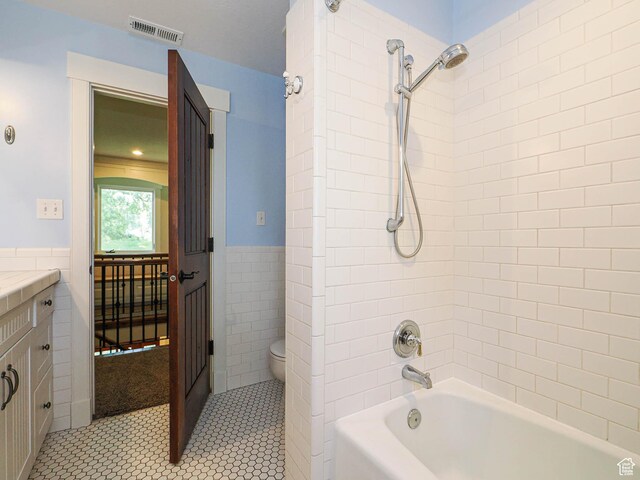919 E 13800 S, Draper, UT 84020 - bathroom with tile walls, toilet, tub / shower combination, tile patterned floors, and vanity