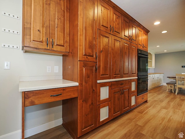 919 E 13800 S, Draper, UT 84020 - kitchen with light wood-style floors, baseboards, brown cabinetry, light countertops, and recessed lighting