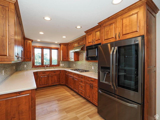 919 E 13800 S, Draper, UT 84020 - kitchen featuring stainless steel fridge, under cabinet range hood, black microwave, light wood finished floors, and brown cabinetry