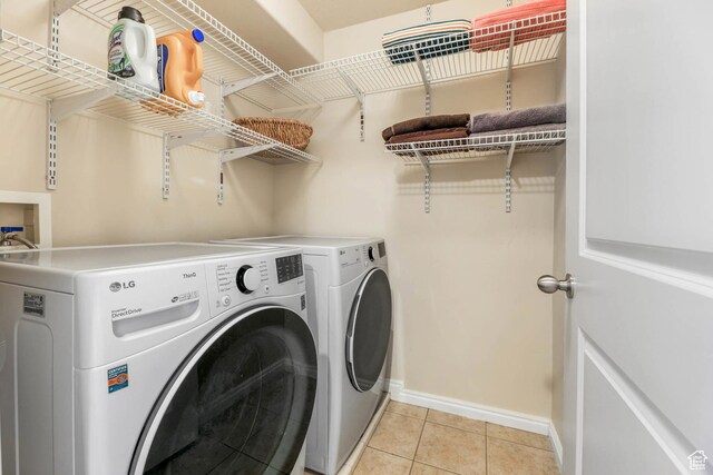 7198 S Milky Hollow Ln, West Jordan, UT 84084 - washroom with washing machine and clothes dryer, baseboards, and light tile patterned flooring