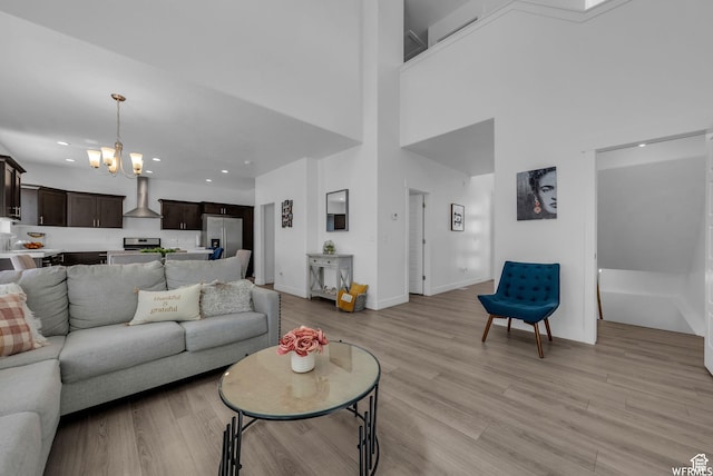 7217 N Hidden Steppe Bnd, Eagle Mountain, UT 84005 - living room featuring a chandelier, recessed lighting, light wood-style flooring, a towering ceiling, and baseboards