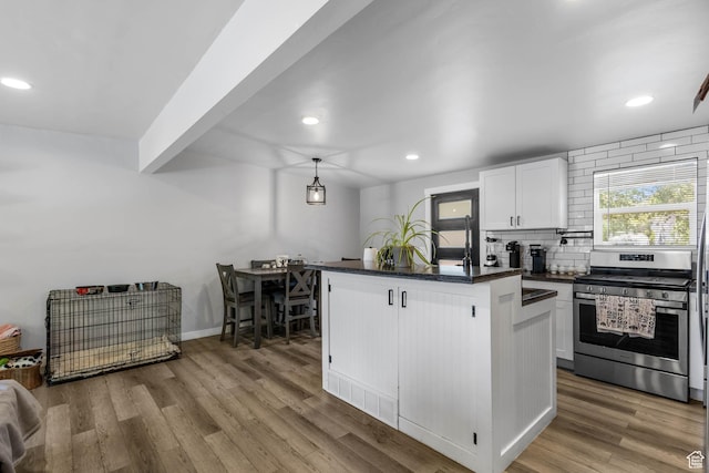 4206 S Whipoorwhil St W, West Valley City, UT 84120 - kitchen featuring gas range, recessed lighting, decorative backsplash, white cabinets, and light wood finished floors
