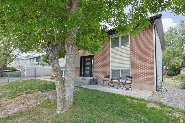4206 S Whipoorwhil St W, West Valley City, UT 84120 - back of house featuring brick siding