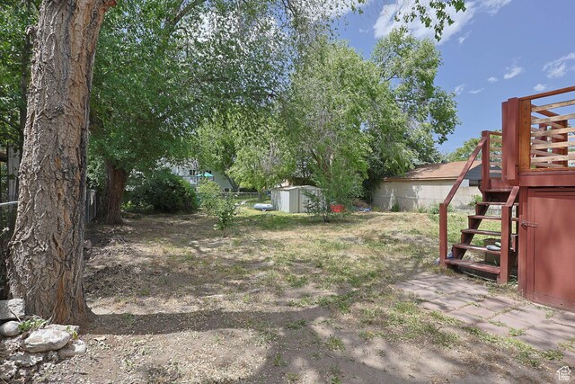 4206 S Whipoorwhil St W, West Valley City, UT 84120 - view of yard with stairway and a deck