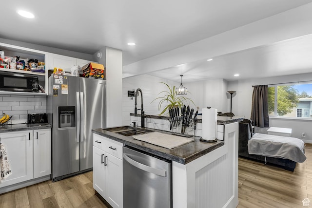 4206 S Whipoorwhil St W, West Valley City, UT 84120 - kitchen with stainless steel appliances, white cabinets, light wood-type flooring, and recessed lighting