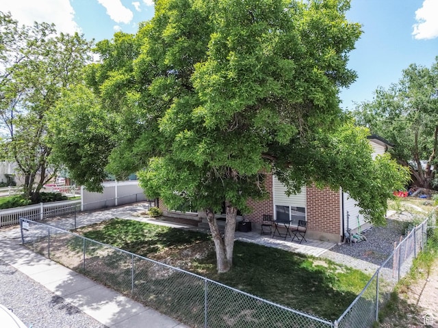 4206 S Whipoorwhil St W, West Valley City, UT 84120 - view of front facade featuring a patio area and a fenced backyard