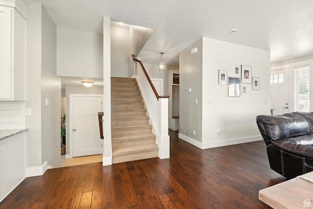 2986 S Stonebridge Dr W, Nibley, UT 84321 - living room with stairs, dark wood-style flooring, and baseboards