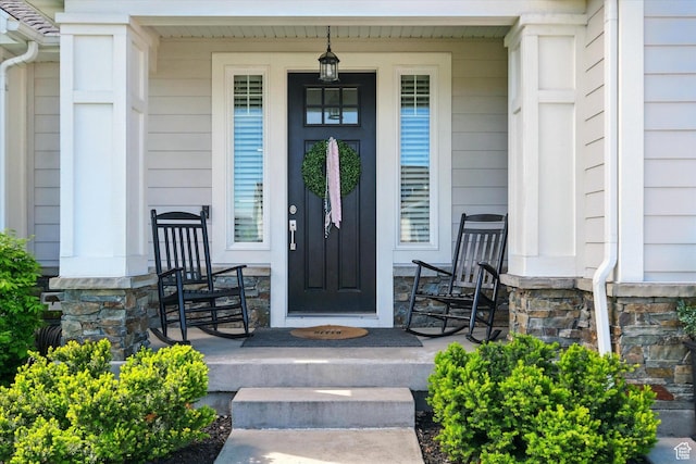 2986 S Stonebridge Dr W, Nibley, UT 84321 - doorway to property with a porch