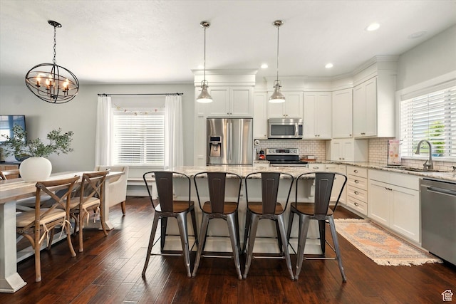 2986 S Stonebridge Dr W, Nibley, UT 84321 - kitchen with stainless steel appliances, a sink, a chandelier, light stone counters, and recessed lighting