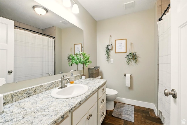 2986 S Stonebridge Dr W, Nibley, UT 84321 - full bath with wood finished floors, baseboards, vanity, and toilet