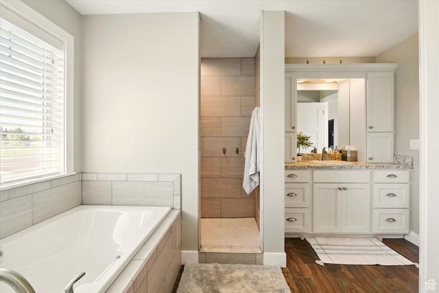 2986 S Stonebridge Dr W, Nibley, UT 84321 - full bathroom with a garden tub, vanity, wood finished floors, and a stall shower