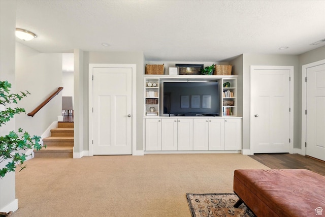 2986 S Stonebridge Dr W, Nibley, UT 84321 - living room with baseboards, stairway, and light colored carpet