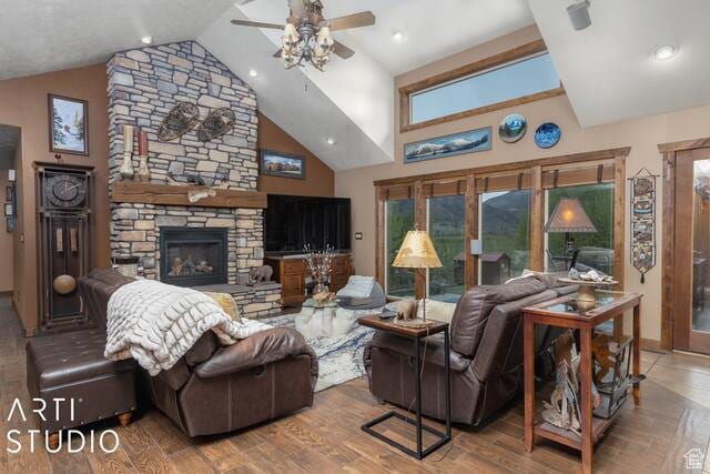 3575 N Foothill Ln, Eden, UT 84310 - living room with a ceiling fan, a fireplace, wood finished floors, baseboards, and high vaulted ceiling
