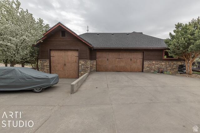 3575 N Foothill Ln, Eden, UT 84310 - view of front of home featuring stone siding, a garage, and driveway