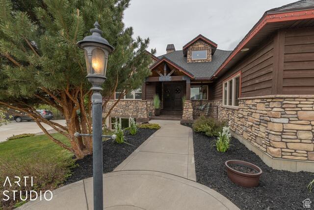 3575 N Foothill Ln, Eden, UT 84310 - doorway to property with stone siding and a chimney