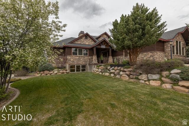3575 N Foothill Ln, Eden, UT 84310 - view of front of home featuring stone siding, a front yard, and a chimney