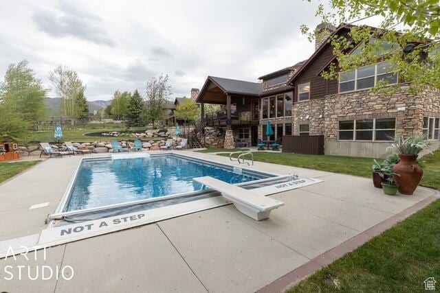 3575 N Foothill Ln, Eden, UT 84310 - outdoor pool with a patio area, a diving board, and a lawn