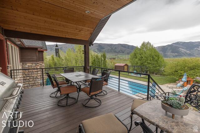 3575 N Foothill Ln, Eden, UT 84310 - deck featuring a mountain view, outdoor dining space, and area for grilling
