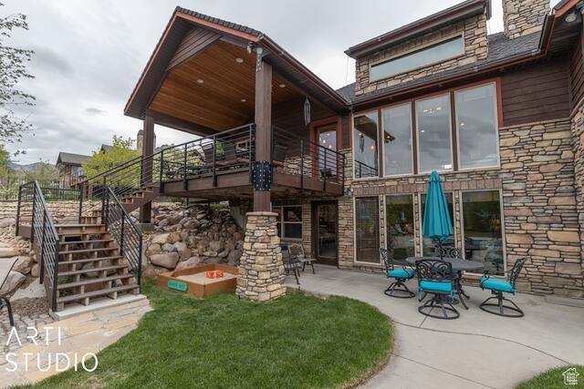 3575 N Foothill Ln, Eden, UT 84310 - rear view of house featuring stone siding, stairway, and a patio
