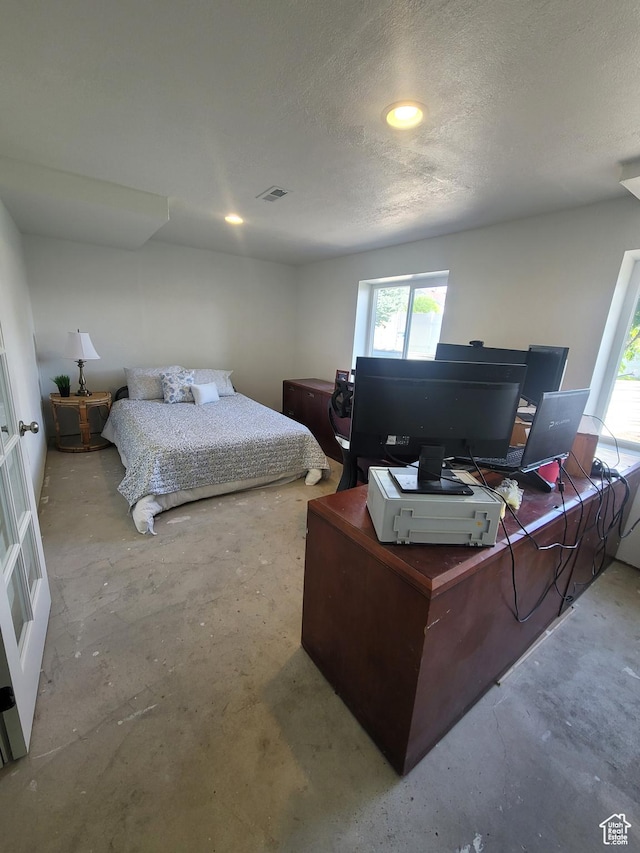 2981 S Pika Dr, West Valley City, UT 84128 - bedroom featuring unfinished concrete flooring, an office area, a textured ceiling, and recessed lighting