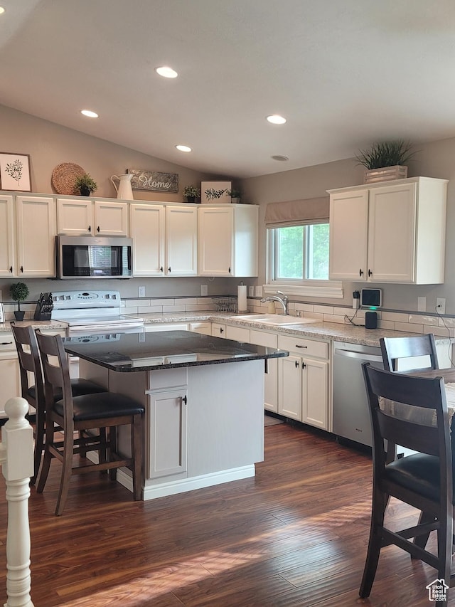 2981 S Pika Dr, West Valley City, UT 84128 - kitchen featuring a sink, stainless steel appliances, white cabinets, a kitchen island, and recessed lighting