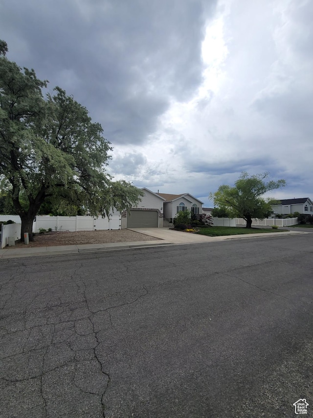2981 S Pika Dr, West Valley City, UT 84128 - obstructed view of property featuring driveway and a garage