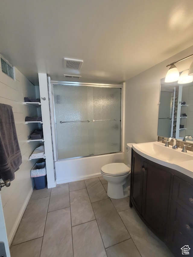 2981 S Pika Dr, West Valley City, UT 84128 - bathroom with toilet, vanity, bath / shower combo with glass door, and tile patterned flooring
