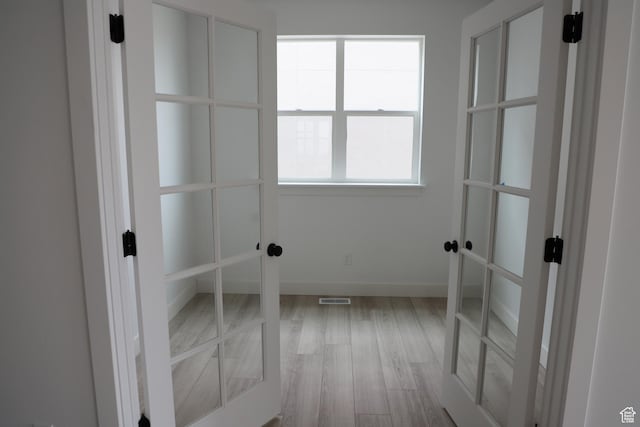 3736 N Janie St Unit 1005, Eagle Mountain, UT 84005 - empty room featuring wood finished floors, french doors, and baseboards