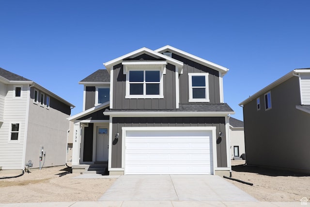 3736 N Janie St Unit 1005, Eagle Mountain, UT 84005 - view of front of home featuring board and batten siding, a garage, concrete driveway, and roof with shingles