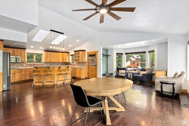 5548 E Emigration Canyon Rd E, Salt Lake City, UT 84108 - dining area with vaulted ceiling, dark wood-style floors, a skylight, a ceiling fan, and recessed lighting