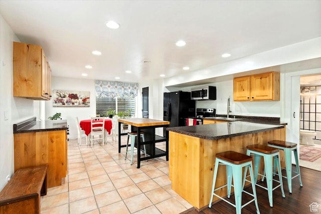 5548 E Emigration Canyon Rd E, Salt Lake City, UT 84108 - kitchen featuring stainless steel appliances, a sink, dark countertops, a kitchen breakfast bar, and recessed lighting